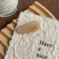 Detail shot of an elegant beige acetate teardrop hair clip featuring chic handmade texture. - Striped Beige
