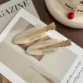 Close-up of elegant beige acetate hair clips with metal clips, chic fashion accessories. - Pair (With Cardboard) / Champagne