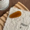 Detailed view of a stylish amber acetate teardrop hair clip, elegant and smooth texture accessory. - Amber