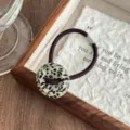 Retro tortoiseshell acetate button hair tie detail shot, showing unique pattern and texture. - Black White Dots