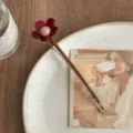 Detailed view of the elegant floral hair clip featuring red petals and a lovely pink center bead. - Big Red Flower - Coffee Rod