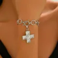 Punk style silver metal bracelet with textured cross pendant and trendy OT toggle clasp. - White K Swirl Bracelet