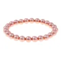 Detailed view of the pink pearl beaded elastic bracelet, showcasing smooth round beads and luster. - Pink Artificial Pearl