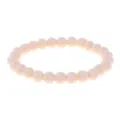 Beige round bead stretch bracelet detail shot, smooth surface, minimalist everyday jewelry. - Light Beige