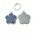 Close-up detail of the rhinestone flower pet tag and metal ring, showing back smooth finish. - Blue Plum Blossom
