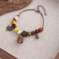 Handmade wooden bead bracelet with acorn and leaf charms, vintage ethnic style detail view. - Style S896 (S896)