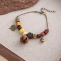 Close-up of vintage handmade wooden bead bracelet with natural acorn and leaf charms detail. - Style S897 (S897)