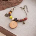 Vintage wooden bead bracelet with acorn leaf charms and tree slice pendant detail close up shot. - Style S898 (S898)
