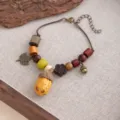 Handcrafted retro ethnic style acorn bracelet with wooden beads and leaf charms for women detail view. - Style S899 (S899)