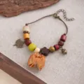 Close-up detail of handmade vintage ethnic style wooden bead bracelet with acorn and seed pendants. - Style S901 (S901)