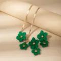 Detail view of the green flower necklace and earrings set featuring stylish snake chain design. - X677-Green