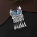 Close-up detail of Chinese ethnic style silver butterfly tassel fridge magnet pendant decor. - P66