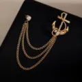Elegant gold anchor brooch pin with sparkling rhinestones and cascading triple tassel chains. - Gold Anchor Tassel Style (Z728)