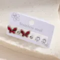 Stainless steel butterfly earring set featuring red patterns, metal balls, and sparkling crystals. - Red Textured Butterfly Stud Earrings Set (E1579-1)