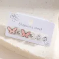 Detail shot of stainless steel stud earrings set featuring pink butterfly and crystal designs. - Pink Enamel Butterfly Stud Earrings Set (E1833-6)