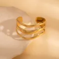Detailed shot of a multi-strand wavy gold open cuff bracelet with a modern geometric design. - Three-Layer Wavy Style / Gold
