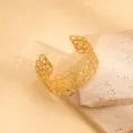 Detail view of a wide gold open cuff bracelet with intricate geometric hollow design. - Woven Mesh Hollow Style / Gold