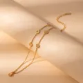 Gold layered bracelet detail shot, minimalist stainless steel round charms with sparkling crystals. - S803