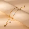 Gold stainless steel flower bracelet detail close-up, elegant white floral charm jewelry. - S797