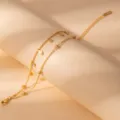 Dainty double layer gold stainless steel chain bracelet with crystal and leaf charms. - S805
