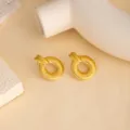 Close-up of vintage gold metal geometric textured stud earrings, minimalist modern jewelry detail. - E4421-4