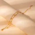 Double layer gold chain bracelet with cross pendants and sparkling rhinestone charms. - S807
