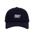 Donkerblauwe honkbalpet voor dames en heren met stijlvol wit geborduurd 1987 ontwerpaccent. - Volwassene / Marineblauw