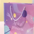 Detail view of pink galaxy paper gift bag with white rope handles and space star patterns. - Starry Sky Gift Bag / Small (17x8.5x14cm) / Pink