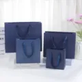 Dark blue paper gift bags detail view, elegant ribbon handles for cosmetic and festival packaging. - Small Size 16x8x17cm / Glazed Blue