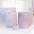 Gradient paper gift bags with star shell design, assorted sizes for holiday gift packing. - Moon & Star