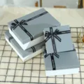 Grey and white gift boxes set with black ribbon bows, perfect for presents and packaging. - Extra Large Single Gift Box (33x25x8cm) / Grey Lid White Base