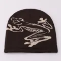Close-up detail of the brown knit beanie featuring a stylish frog jacquard pattern design. - One Size / Coffee Jacquard Frog
