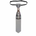 Close-up of British plaid pre-tied tie featuring a delicate crystal pearl chain brooch. - Gray
