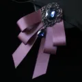 Vintage purple satin bow tie for men featuring an elegant dark blue gemstone brooch accessory. - Deep purple