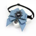 Detailed view of the blue ribbon bow tie featuring a vintage black rhinestone crystal pendant. - Denim Blue