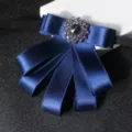 Blue ribbon bow tie with sparkling rhinestone center, perfect for men's business suits. - Blue