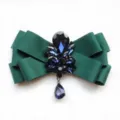 Elegant green ribbon bow tie featuring dark blue crystal rhinestones and teardrop pendant. - Green