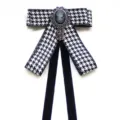 Classic houndstooth bow tie with vintage cameo brooch and black velvet hanging ribbons. - Black & White Houndstooth