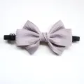 Detailed view of the light purple children bow tie featuring textured fabric and elastic band. - Gray