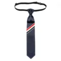 Classic navy blue tie with red white blue striped grosgrain detail and elastic neck strap. - Navy Blue