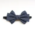 Close-up view of children bow tie, detailed navy blue fabric with white geometric pattern texture. - 3D Grid