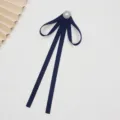 Detailed view of dark blue JK uniform ribbon bow tie with pearl crystal brooch collar accessory. - Back Pin / Dark Blue