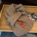 Cozy imitation cashmere knit scarf in camel brown with red embroidery ribbon for winter warmth. - Bow Embroidery Style / Dark Khaki