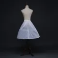 Detailed view of a white fluffy petticoat crinoline with hoop structure for dress volume. - Laced Two Steel Rings