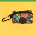 Detailed closeup of the floral pattern dog waste bag holder with black zipper and carabiner. - One Size / Black Hawaii