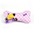 Detail view of pink plaid bone dog chew toy showing cute cartoon puppy print and soft fabric. - Happy Dog