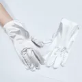 Detailed view of elegant white satin short gloves, perfect for weddings, parties, and evening events. - Approximately 23cm / White