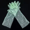 Detailed close-up shot of sheer mint green mesh gloves decorated with elegant white pearls. - Kids One Size / Light Green