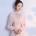 Detail view of pink chiffon long sleeve shrug, delicate lace stand collar, elegant evening wear. - Pink