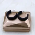 Detailed shot of matte black minimalist geometric C-hoop earrings, modern style accessory. - Flat C-Hoop